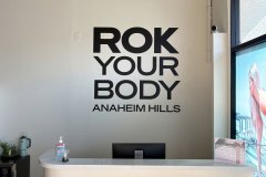 BODYROK custom interior wall sign at the reception desk in Anaheim Hills, California