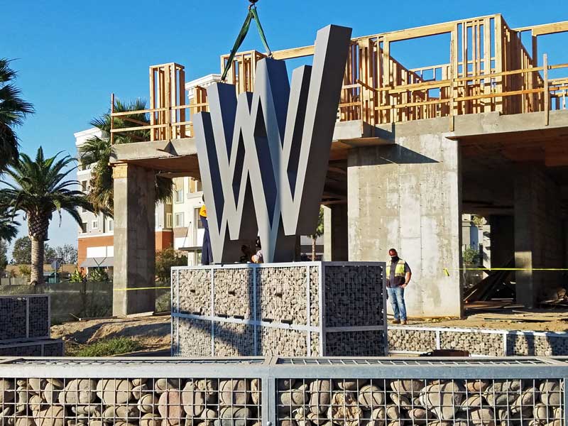 WW sign being hoisted for one of the landmark signs