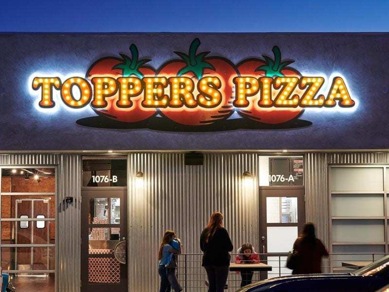 Toppers Pizza uses a mix of channel letters with casino lighting in the front and a back-lit halo effect called halo-lit.