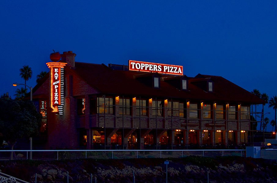 Neon signs using the business name are the go-to for restaurant signs like this one, Toppers Pizza.