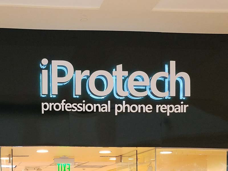 Storefront signs like these halo lit letters for iProtech stand out without going overboard.