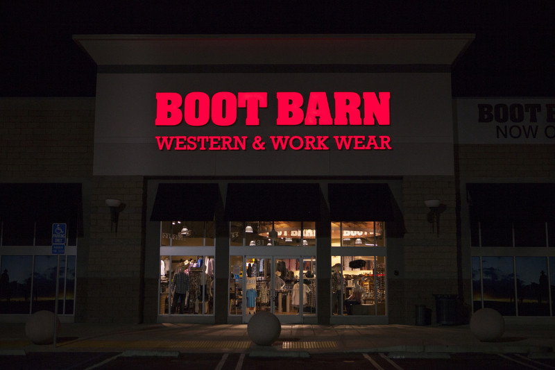 Custom storefront signs like this front lit channel letter sign for Boot Barn really stand out at night.