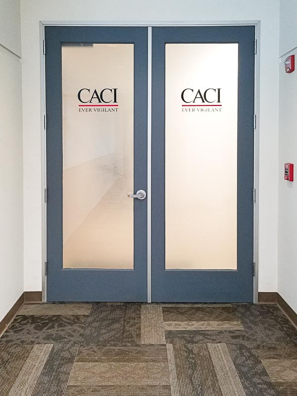 These indoor signs in the lobby area for CACI in Goleta use frosted glass to create privacy while still making a good first impression.