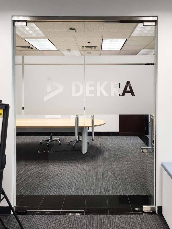 Logo signs or custom lobby signs can even be used to cover conference room doors like this one for Dekra in Oxnard, CA.