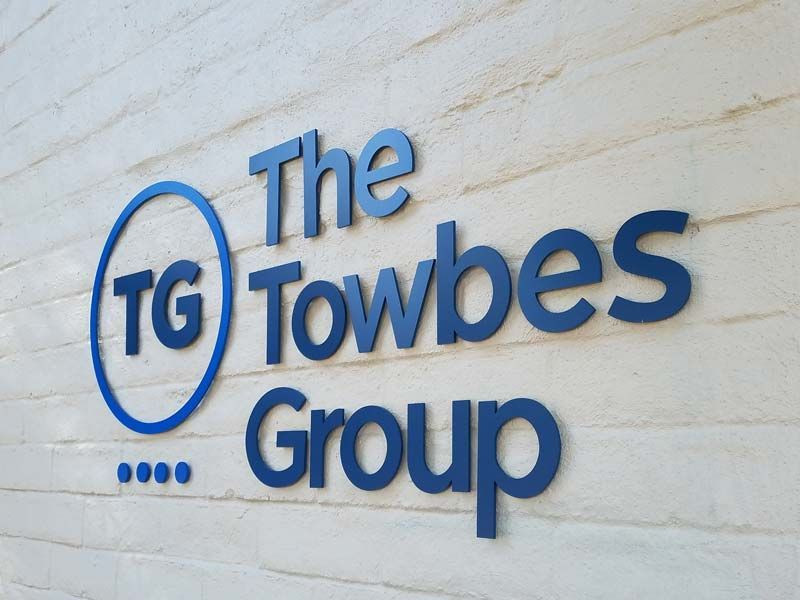Office signs that match your exterior signage have a consistent feel throughout – The Towbes Group, Santa Barbara, CA.