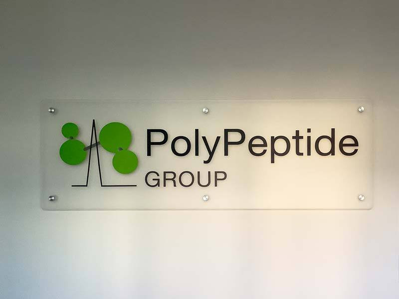 Interior office signs like this acrylic sign for PolyPetide Group in Torrance, CA add polish to the business location.