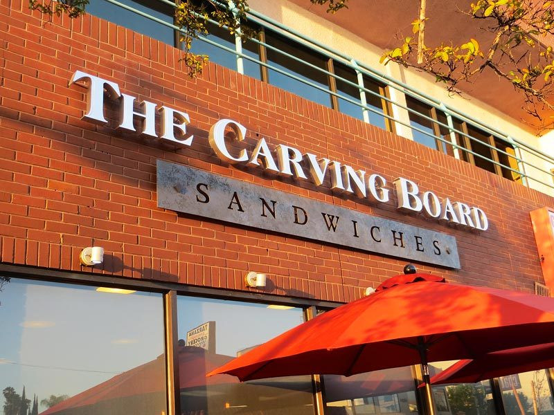 Custom building sign for The Carving Board Sandwiches in Woodland Hills, CA uses channel letters.