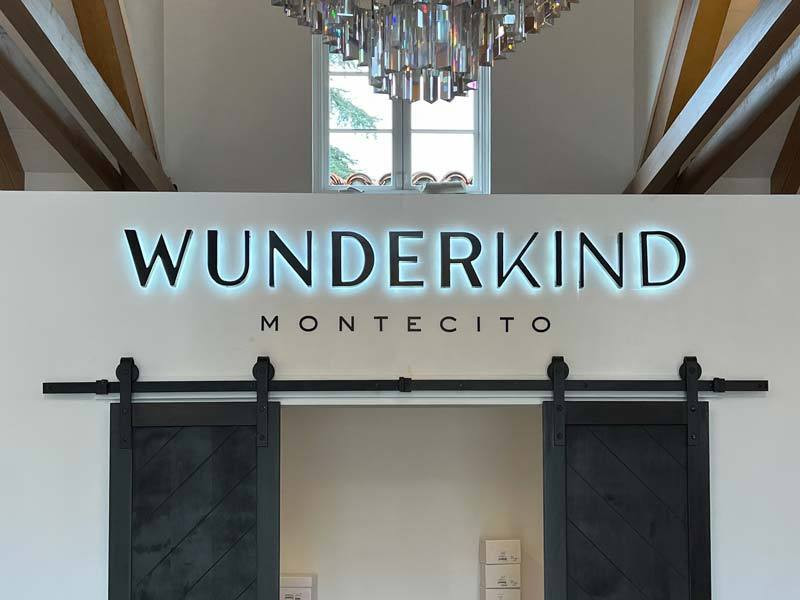 Indoor building signs like this one for Wunderkind in Montecito, CA show more than the company's logo. They create a since of place.