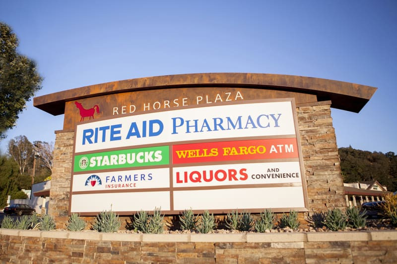 Custom signs like this monument sign for Red Horse Plaza in Ojai make it easy to add and remove tenants.