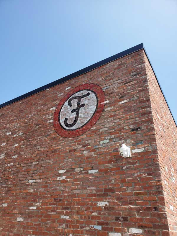 Outdoor signs, such as hand-painted graphics on brick, add polish and evoke a nostalgic feeling about a former era.