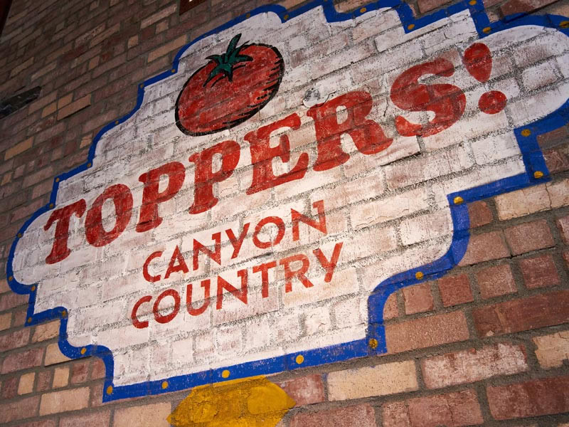 Sign products like hand-painted graphics add good vibes to old buildings, especially on brick walls.