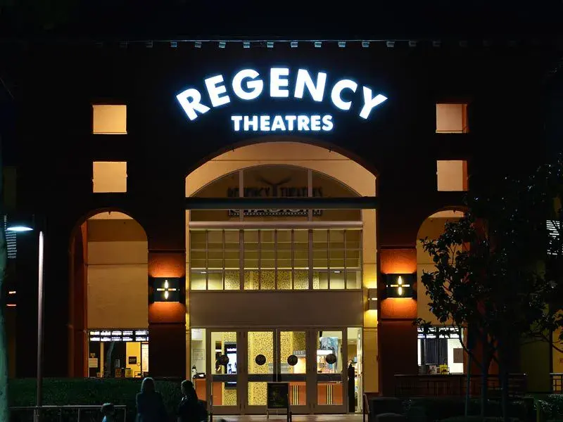 The Regency Theatres in Agoura Hills illuminated channel letter sign at night before it closed.