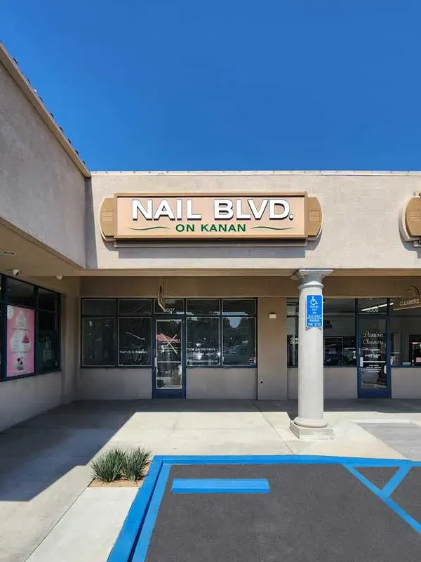 Nail BLVD channel letter and lightbox storefront sign.