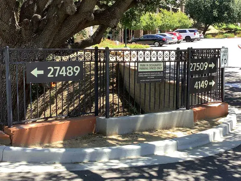 Parking lot wayfinding signs, created as part of the property’s cohesive sign system to improve navigation and visitor experience.