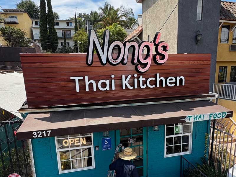 Open face channel letter sign for Nong's Thai Kitchen in Los Angeles, California.