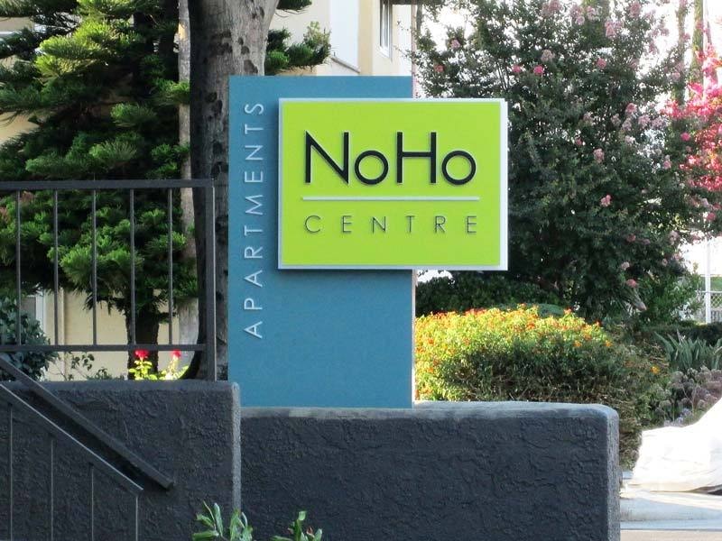 NoHo Centre Apartments monument sign in North Hollywood, CA featuring push-through channel letters integrated into an illuminated cabinet face for clean, modern residential branding.