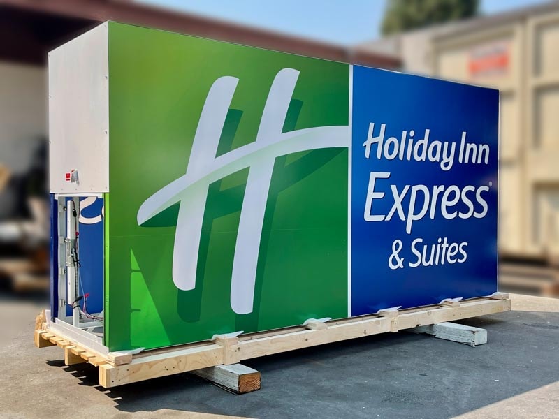 Holiday Inn Express illuminated lightbox monument sign during fabrication, showcasing aluminum cabinet construction and internal LED illumination.