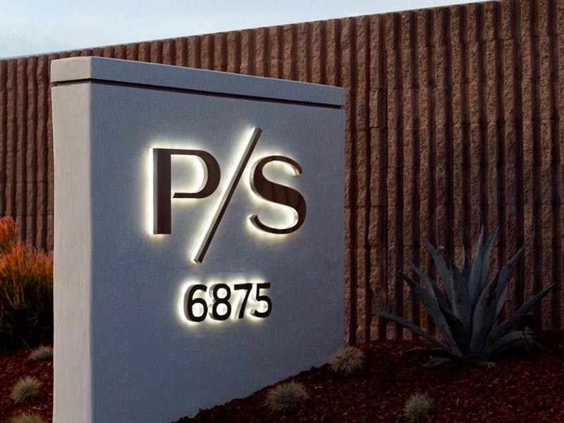 Private Suite LAX illuminated monument sign in Los Angeles, CA, featuring halo-lit dimensional letters on a clean stucco monument structure.