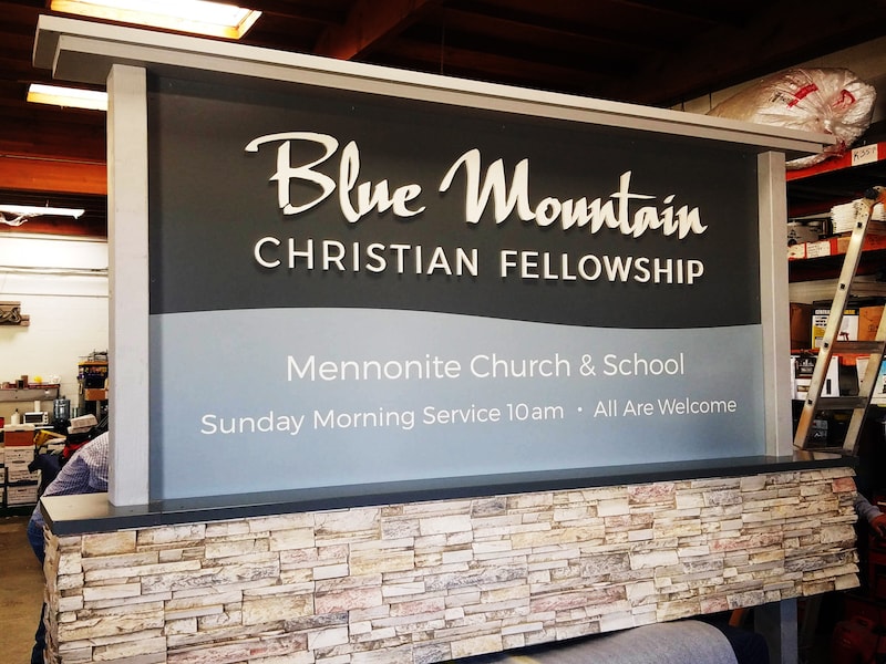 Blue Mountain Christian Fellowship monument sign in Walla Walla, WA constructed with a stone veneer base, high-density urethane (HDU) components, acrylic panels, and dimensional lettering.