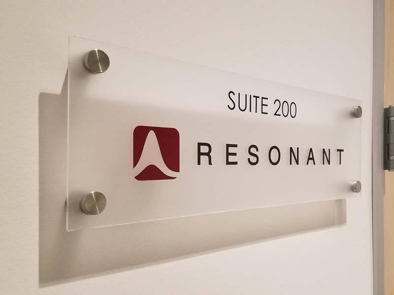 Custom acrylic interior office sign for Resonant—designed for a modern, professional appearance with clear suite identification.