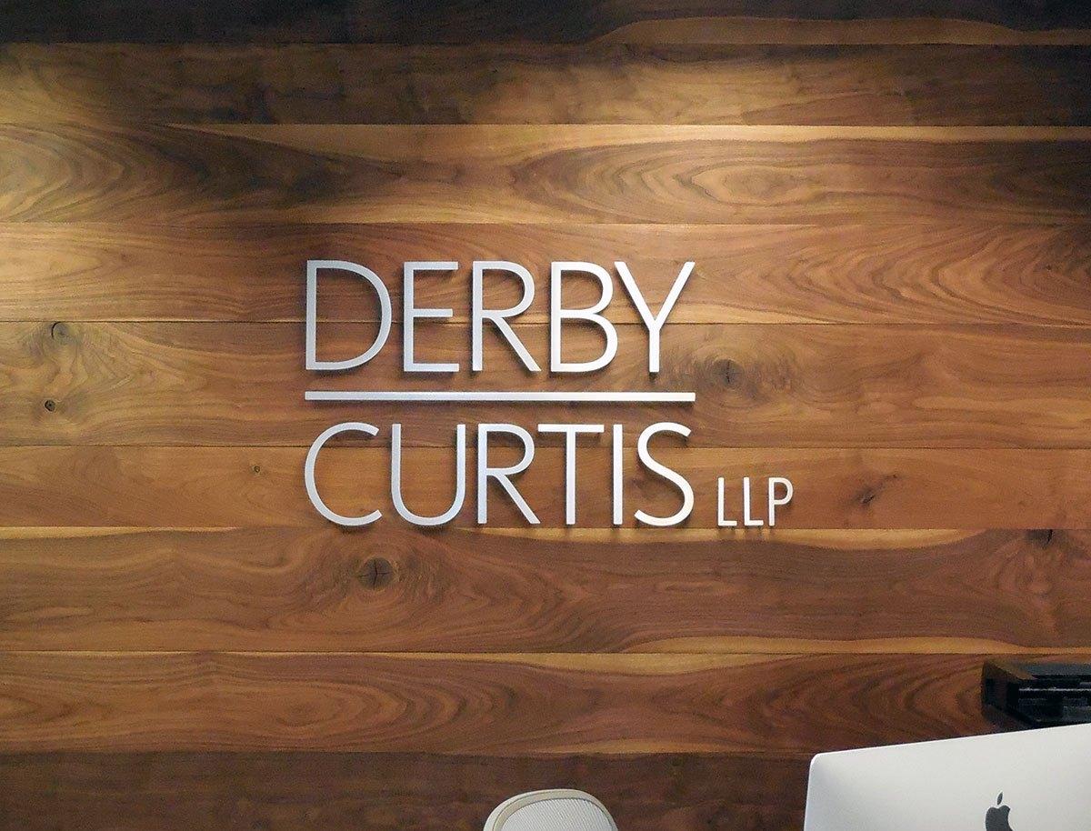 A custom office sign for Derby Curtis LLP—combining clean design, premium materials, and strong brand presence at the point of entry.