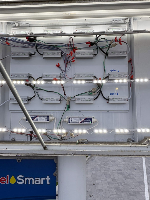 LED power supplies and lighting modules installed during a sign retrofit project, replacing older fluorescent components with modern energy-efficient technology.