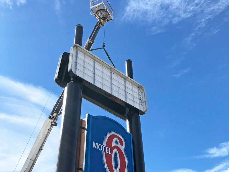 Motel 6 pylon sign undergoing LED lighting retrofit and cabinet sign service by Dave’s Signs