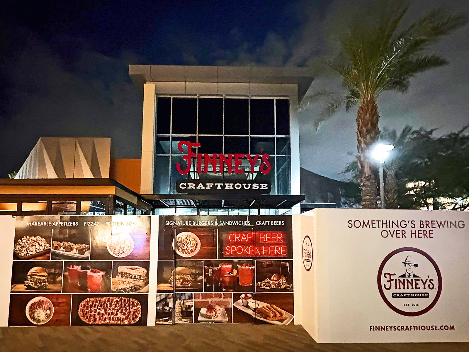 Branded construction barricade graphics featuring food photography and restaurant signage for Finney’s Crafthouse in Las Vegas, NV.